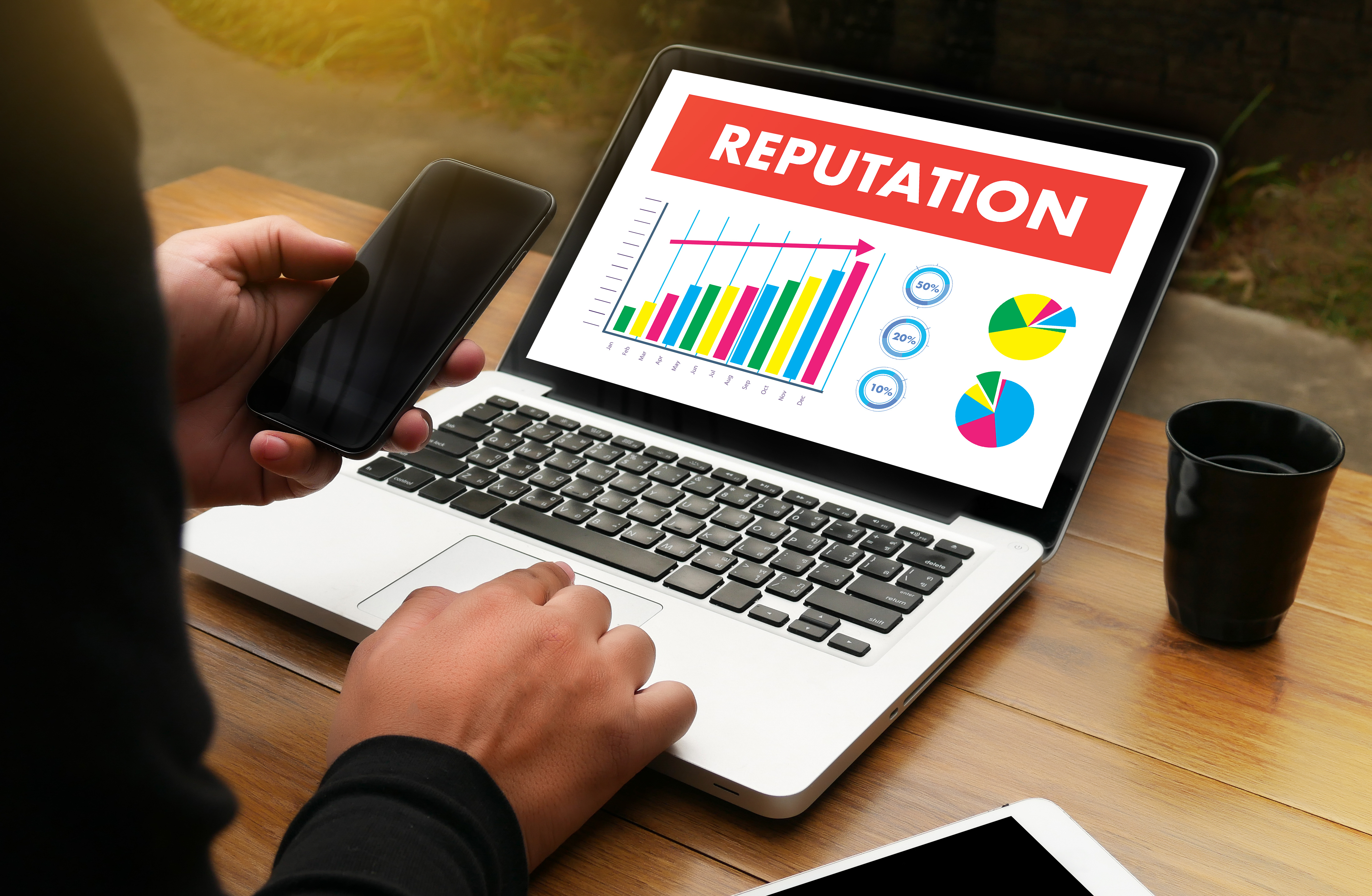 A laptop displaying a graph labeled reputation